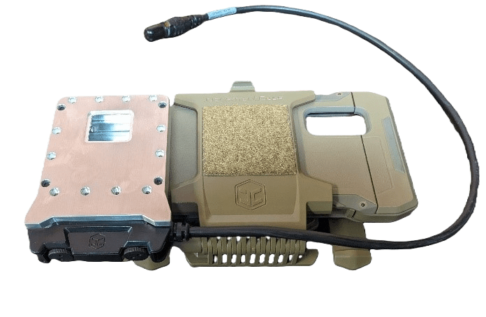 Military-grade communication device with a rugged case, metal plate, and attached cable.