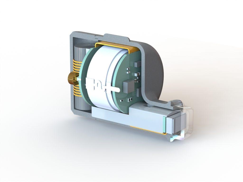 Cutaway view of a mechanical component, featuring a coil, a cylindrical core, and various connectors and electronic parts, all housed within a metallic frame.