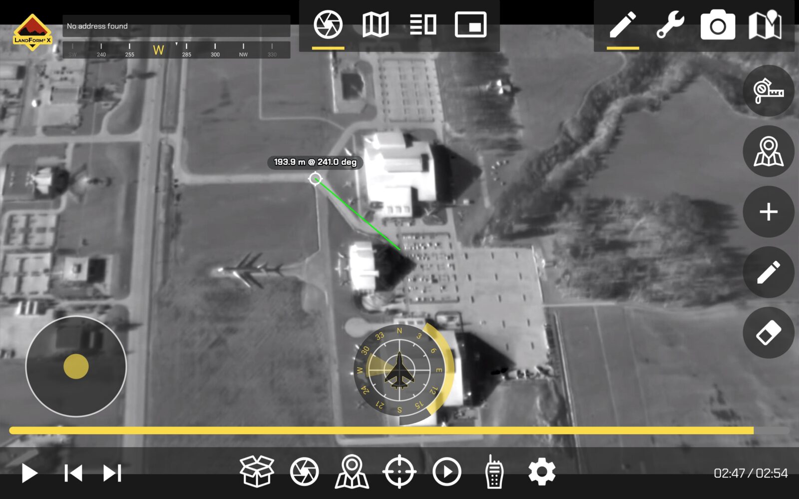 Infrared aerial view of buildings and a parked airplane, with a measurement of 193.8 m at 210 degrees displayed. User interface elements and a compass overlay the image.