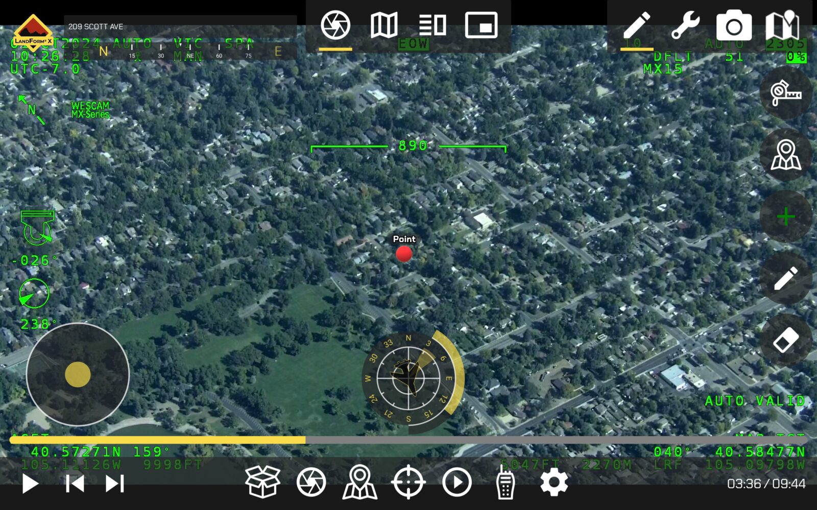Aerial view of a residential neighborhood with a marked point labeled "Point." The image includes various on-screen navigation and coordinate data overlaid.